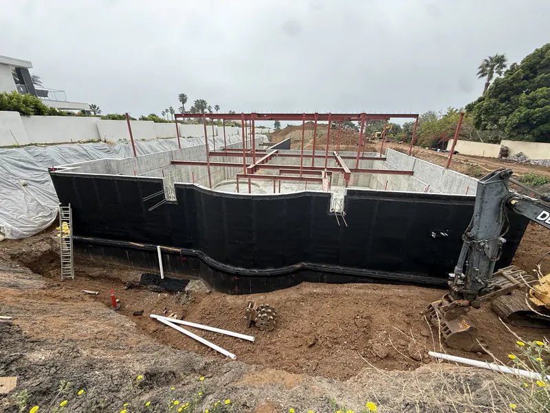 Below grade waterproofing membrane running the full height of a new foundation wall