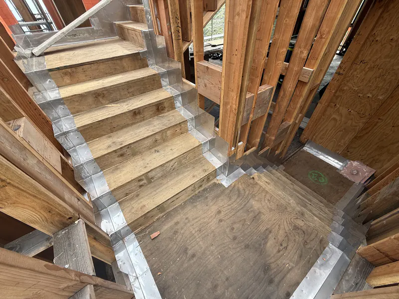 Concrete stair and landing restored and waterproofed inside a framed structure