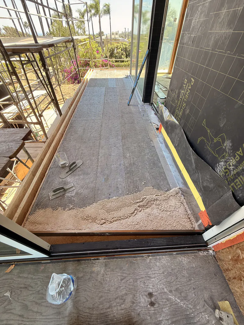 Pedestrian traffic coating finished on an exterior walkway between building and rail