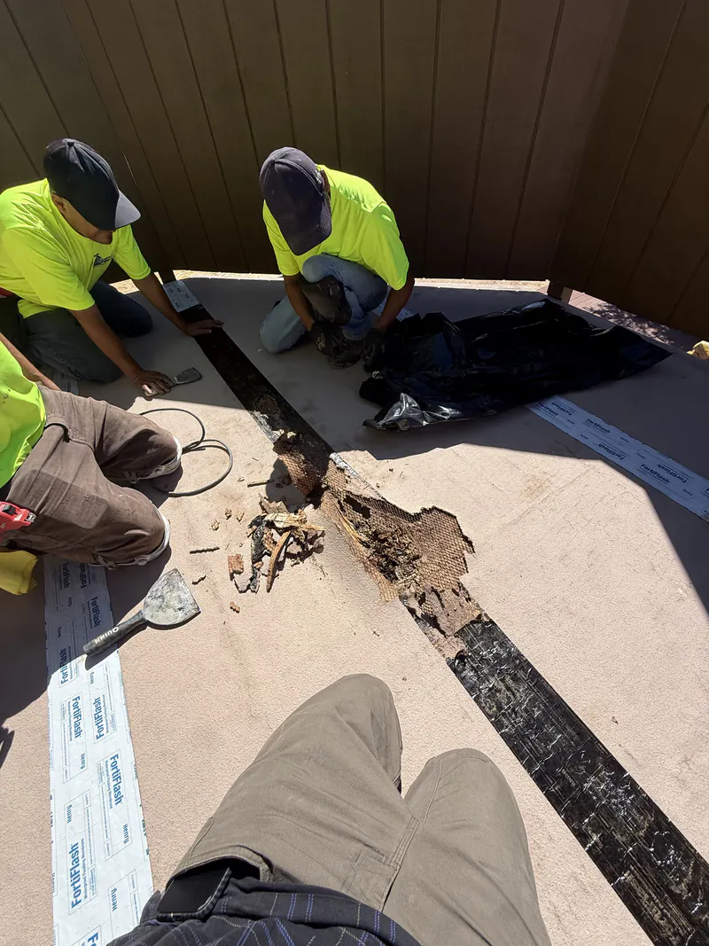 KCJ Contracting crew tearing off a failed deck coating down to sound substrate