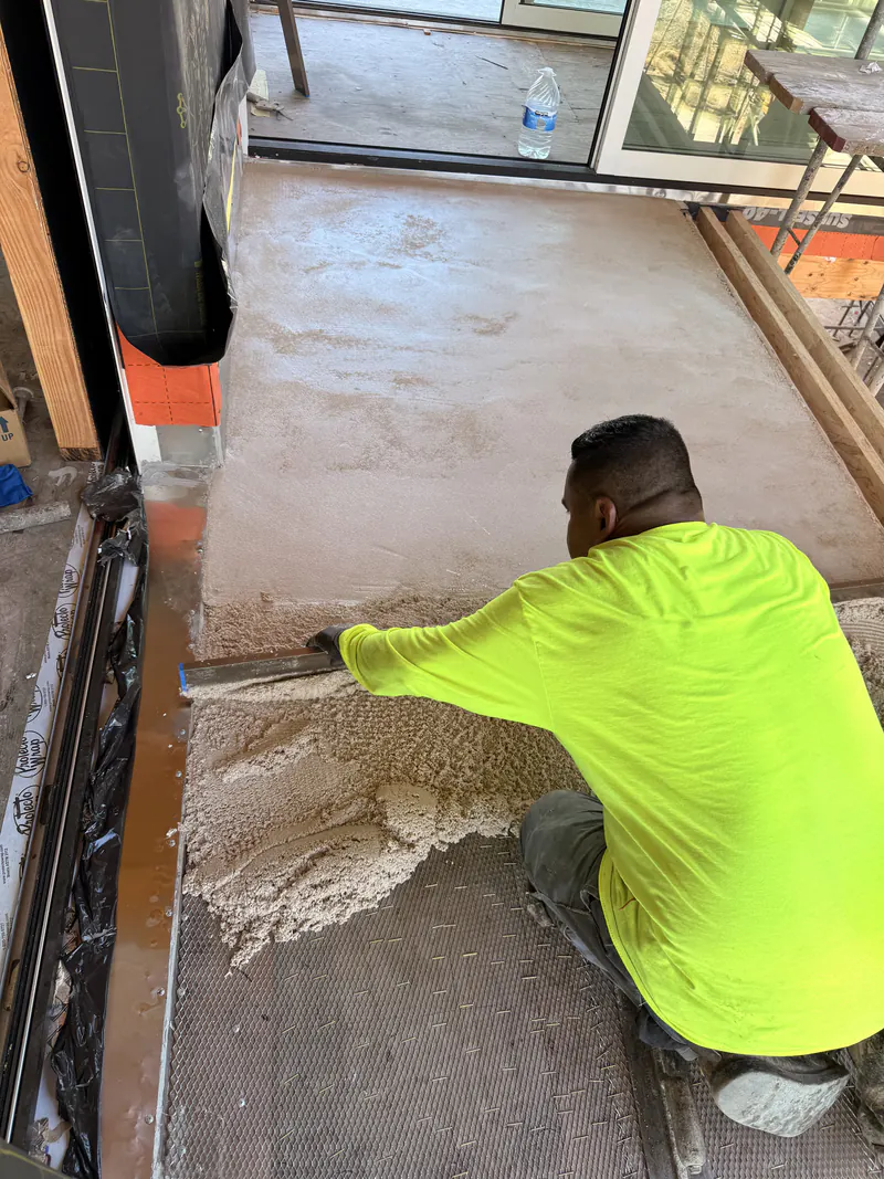 KCJ Contracting installer trowelling an epoxy coating into a corner detail