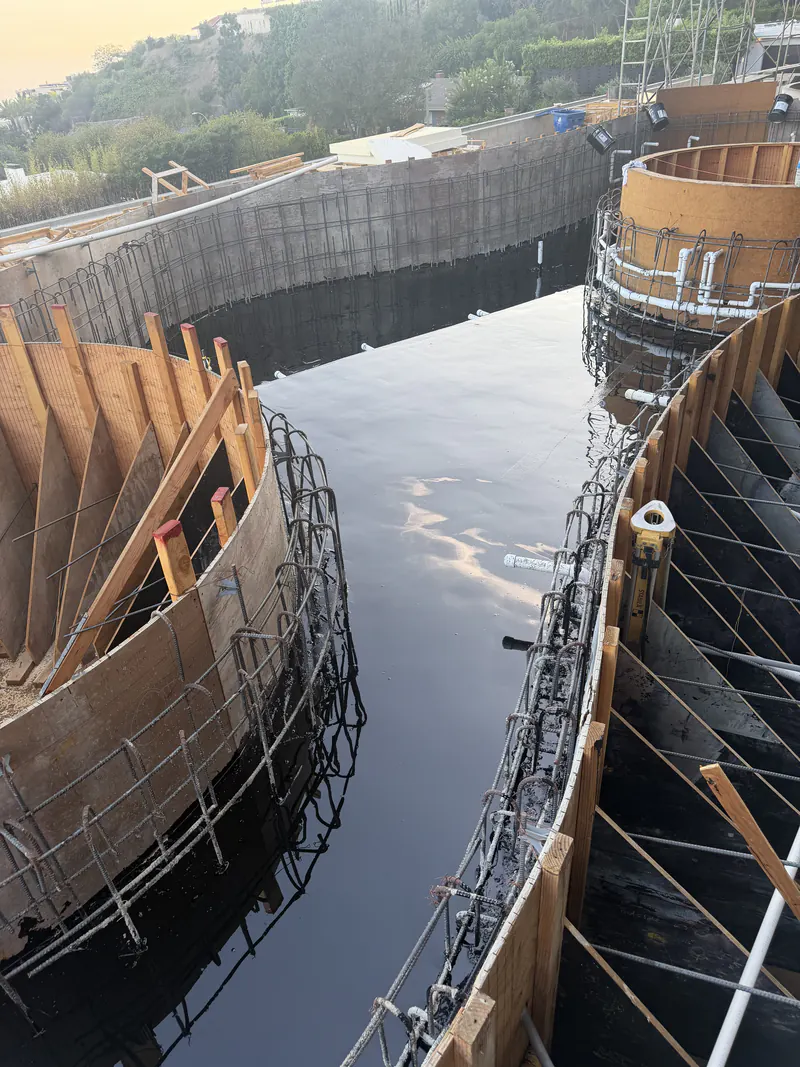 Standing water held on a finished waterproofing membrane during a flood test