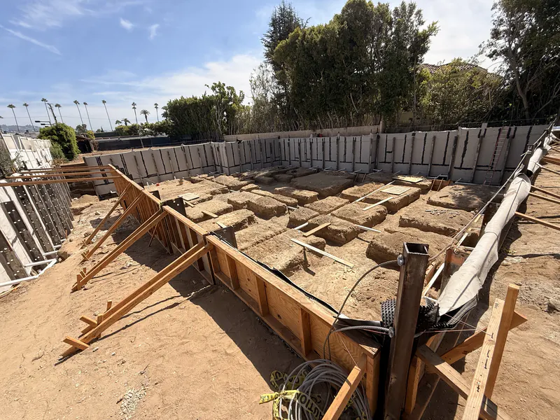 Open foundation excavation with shoring in place, ready for below grade waterproofing