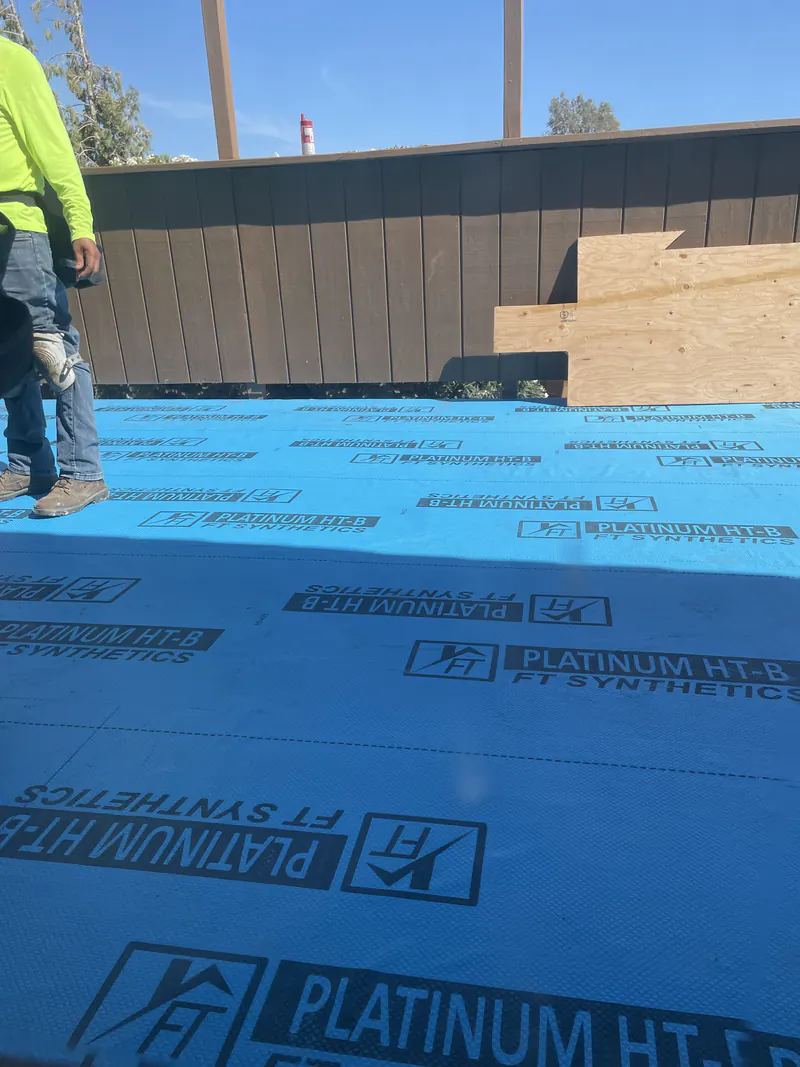 Synthetic roofing underlayment laid over a low slope roof deck