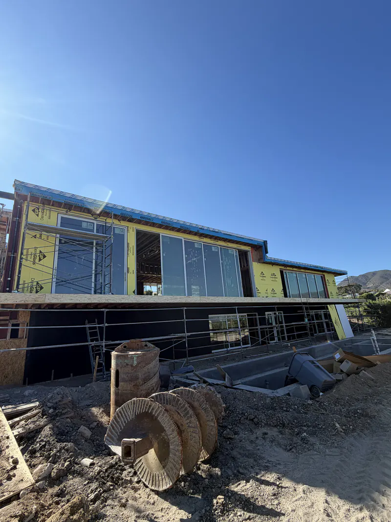Exterior sheathing in place on a modern custom home, ready for the air and weather barrier