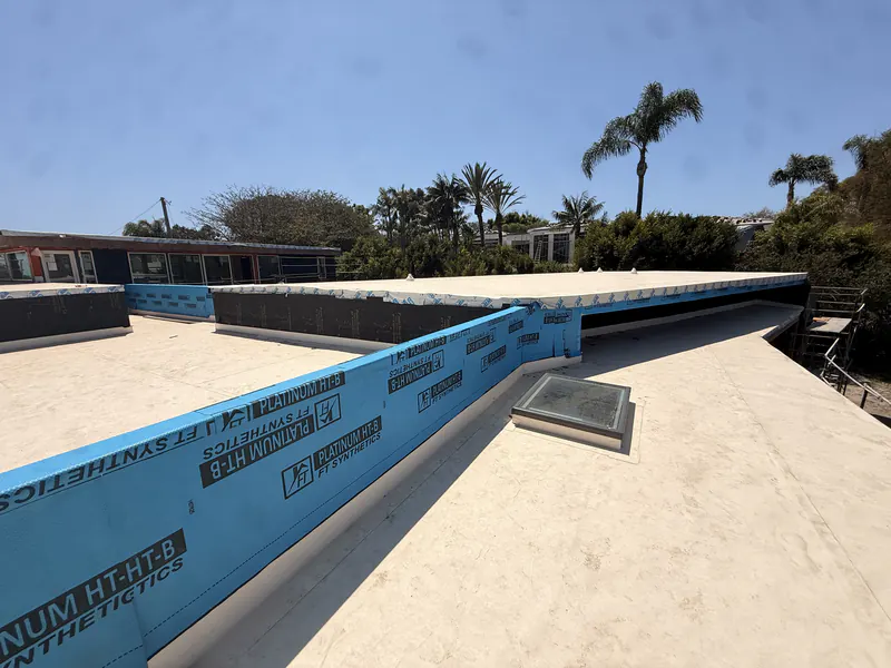 Waterproofing underlayment on a sloped ramp before the traffic coating is applied