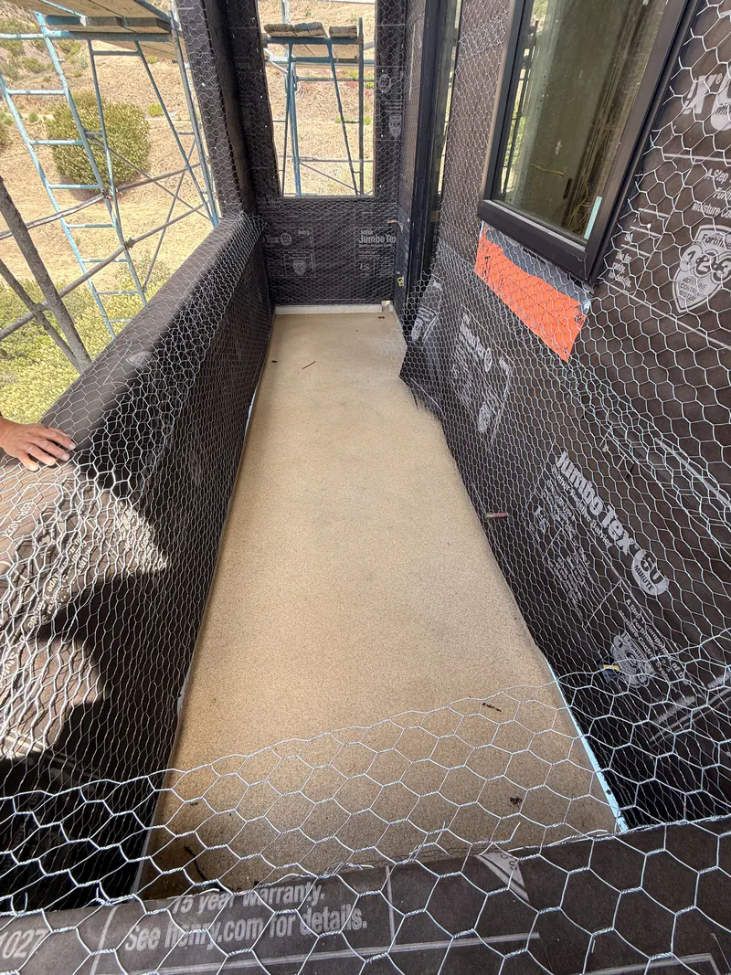 Pedestrian traffic coating over lath and a waterproofed walkway deck