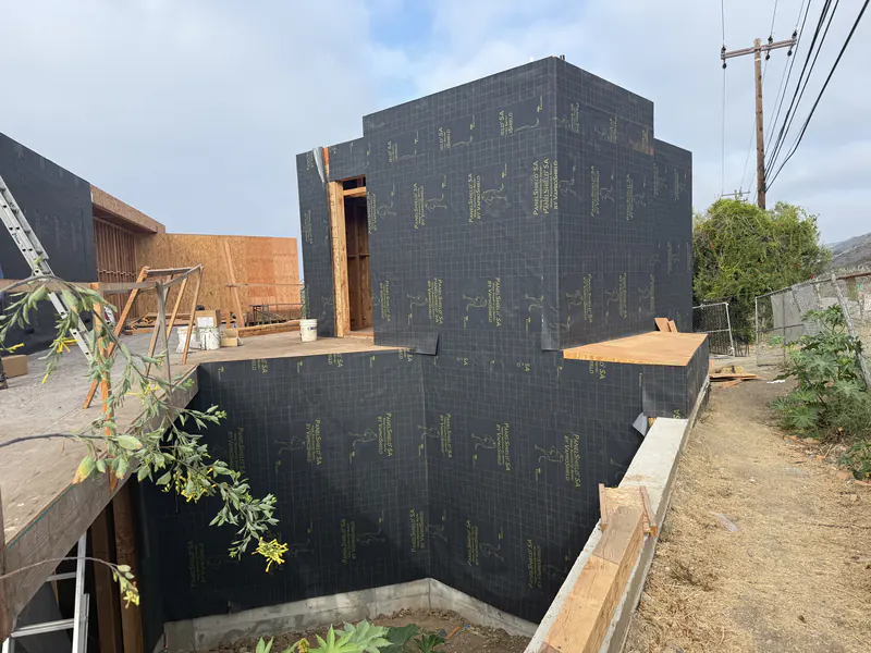 Custom home fully wrapped in a weather resistive barrier before cladding